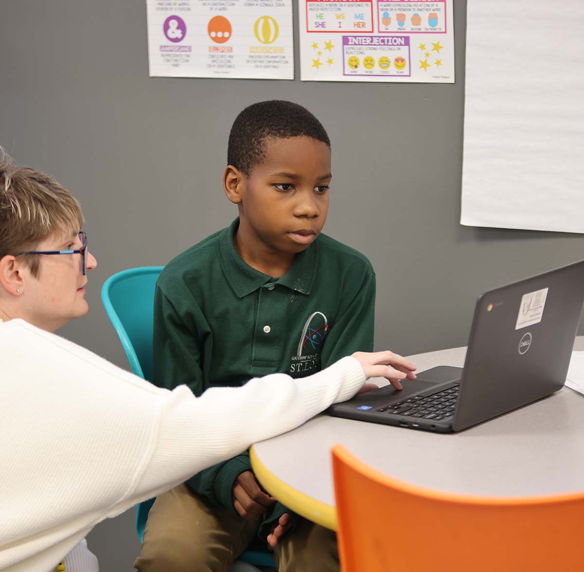 GSA St. Louis South Teacher and student interacting at a classroom desk